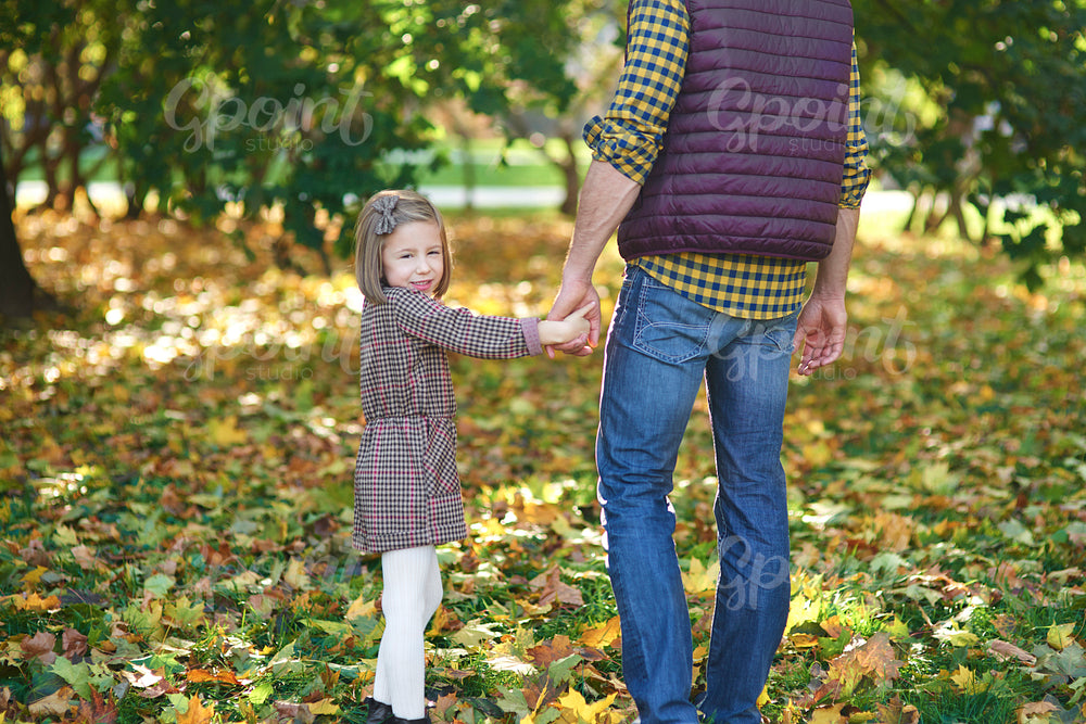 Rear view of father and daughter during autumn walk
