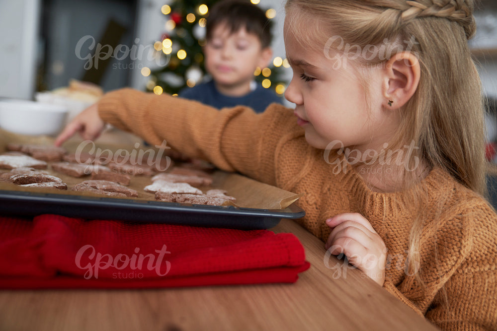 Profile view of girl taking homemade gingerbread cookie