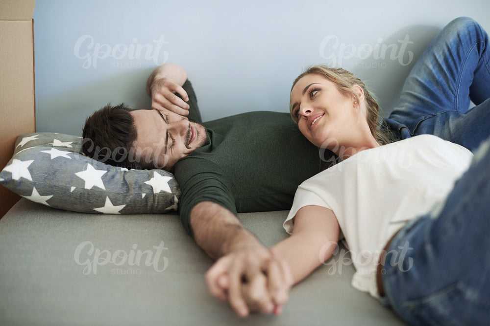 Woman and man having rest during moving house