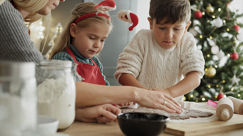 Video of children and mother cutting out gingerbread cookies