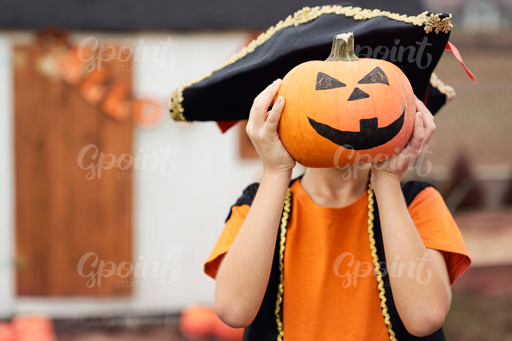 Portrait of boy with pumpkin