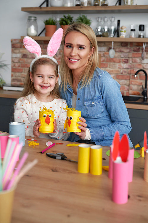 Portrait of mother and daughter with handmade Easter chickens