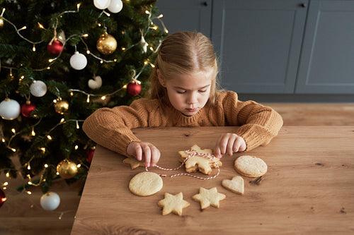Girl packing cookies for Santa Claus