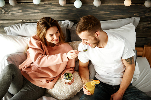 Woman sharing breakfast with man