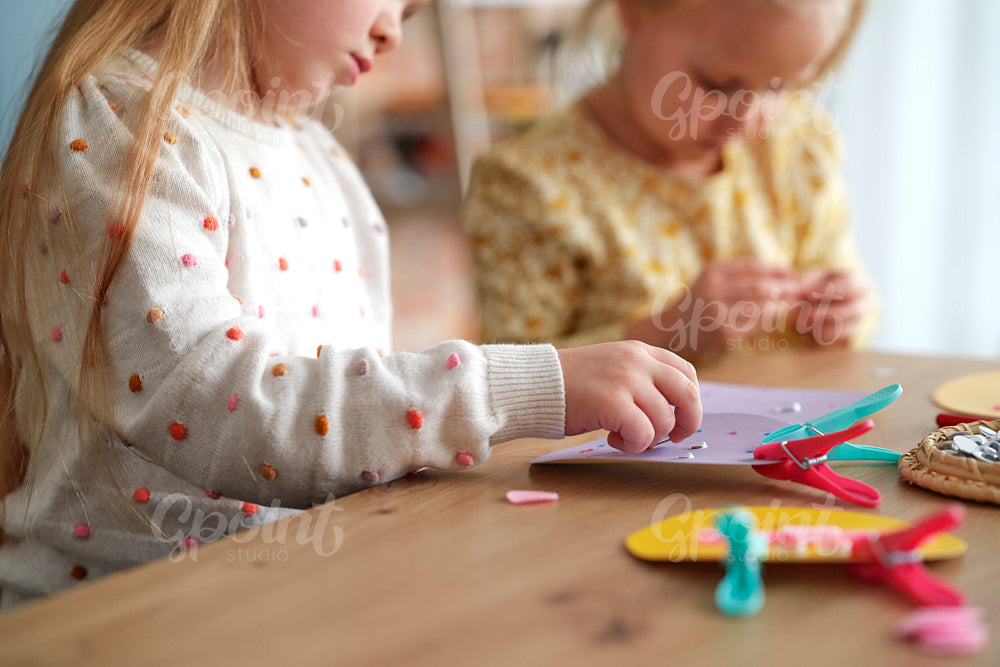 Close up of two child preparing decoration together at home