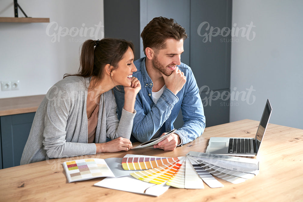 Caucasian couple choosing colors for new house