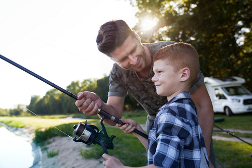 Father and son spending time on fishing together