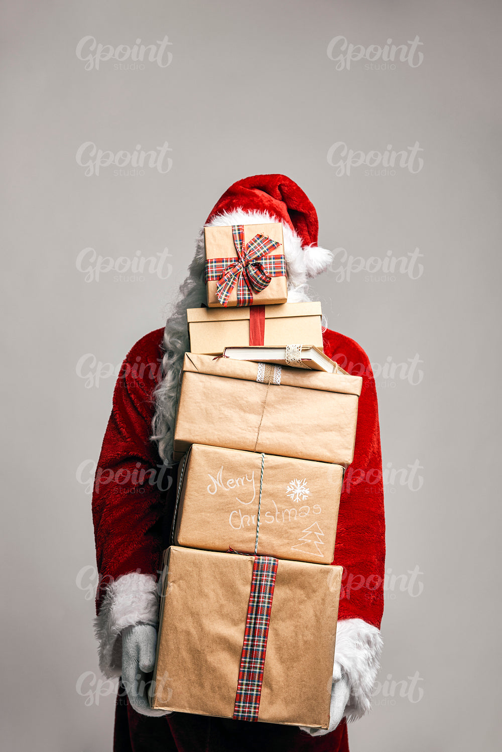 Santa Claus holding holding stack of Christmas presents