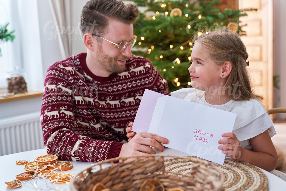 Little girl sending letter to Santa Claus