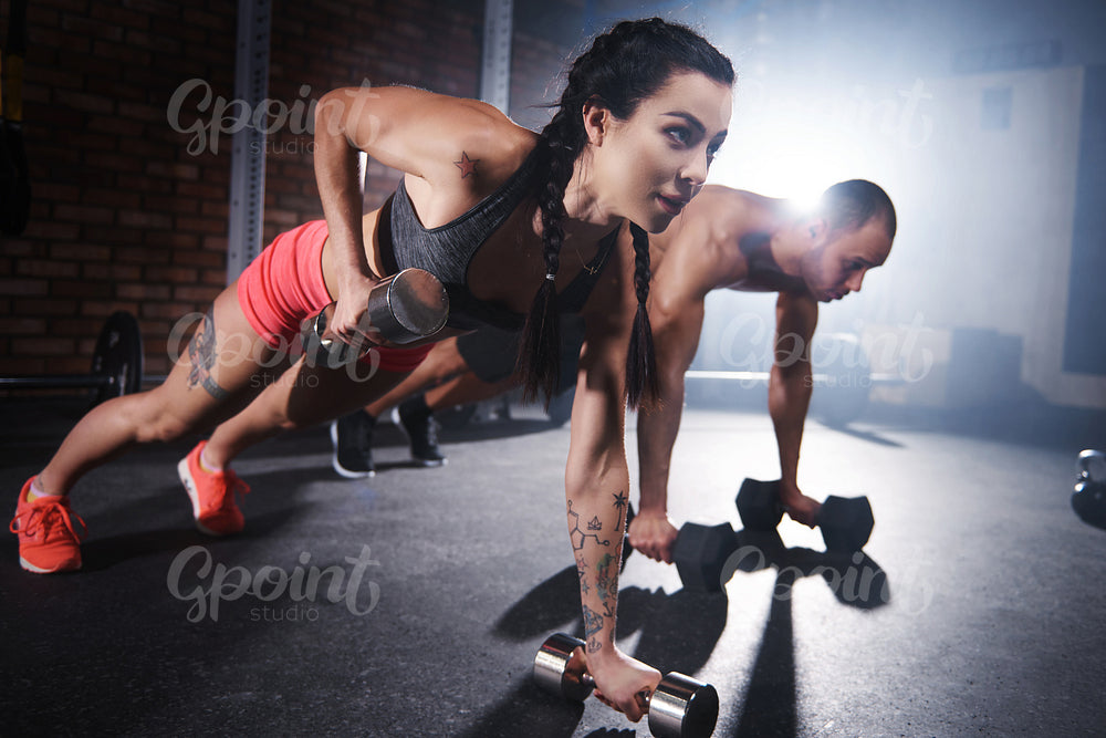Athletes lifting weights and doing push ups