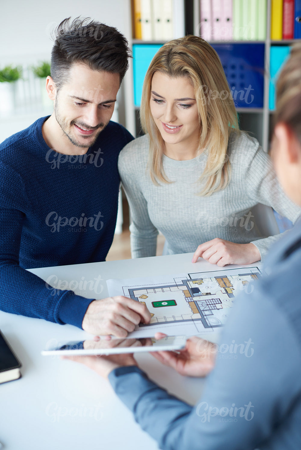 Business woman having conversation with couple