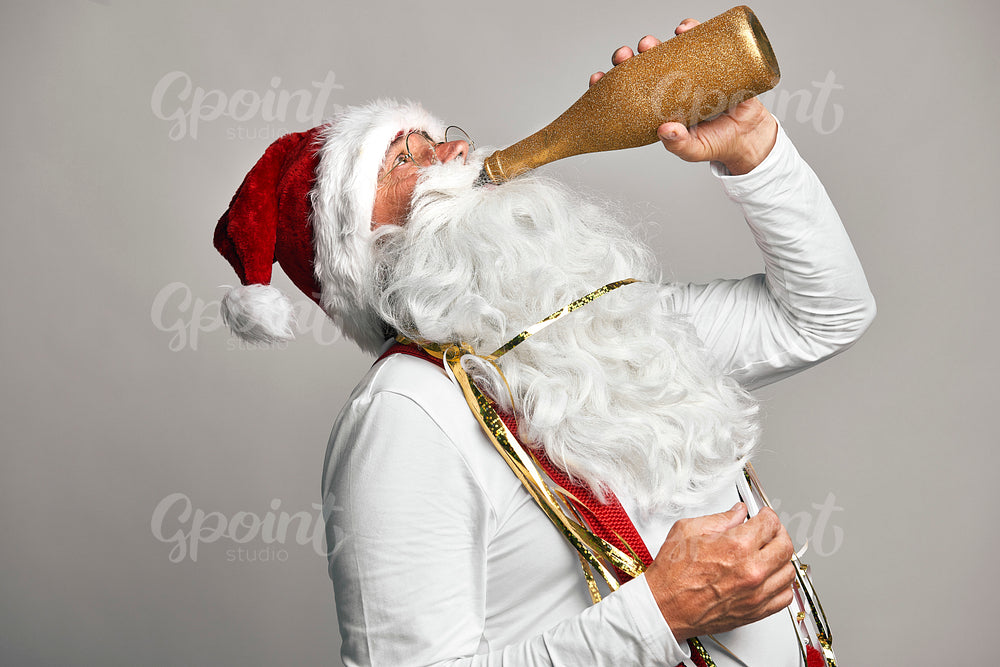 Caucasian Santa Claus celebrating with glass of champagne