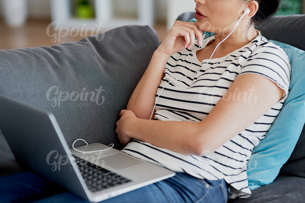 Close up of young woman in front of laptop at home.