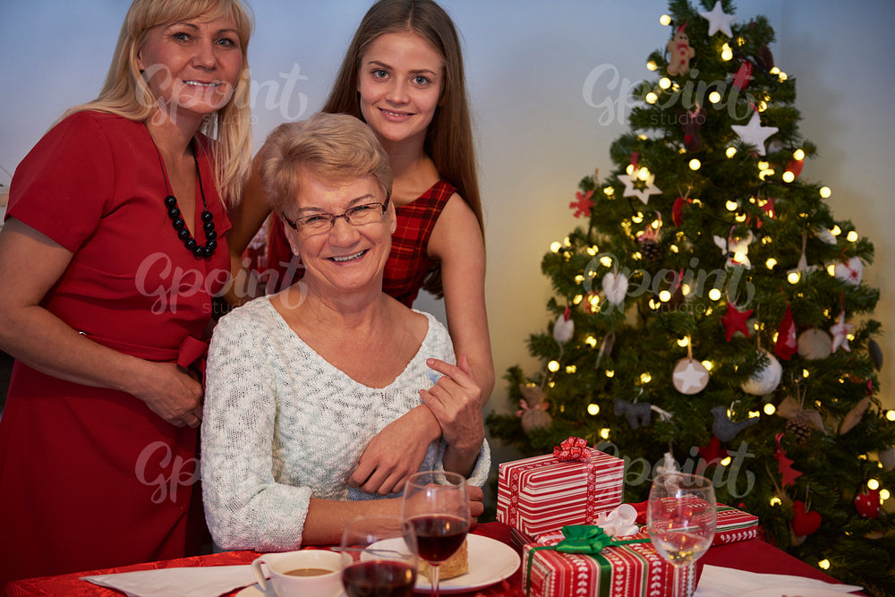 Three women next to the christmas tree