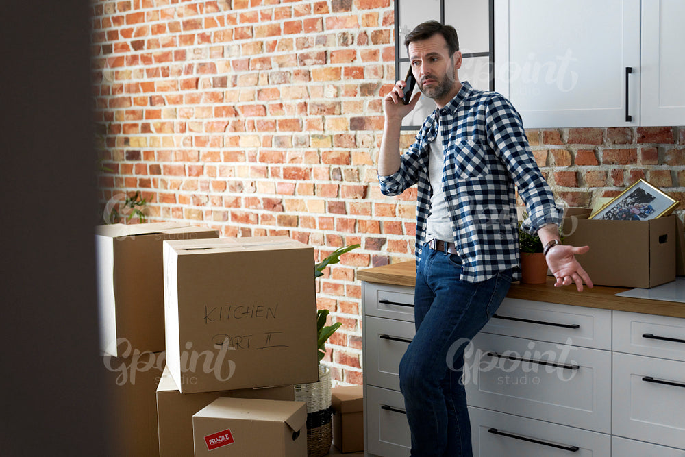 Displeased man calling during moving house