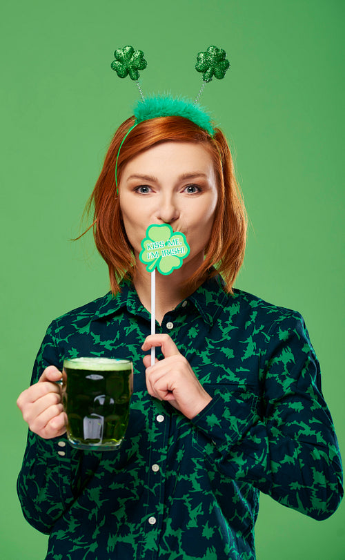 Portrait of woman with beer celebrating Saint Patrick's Day