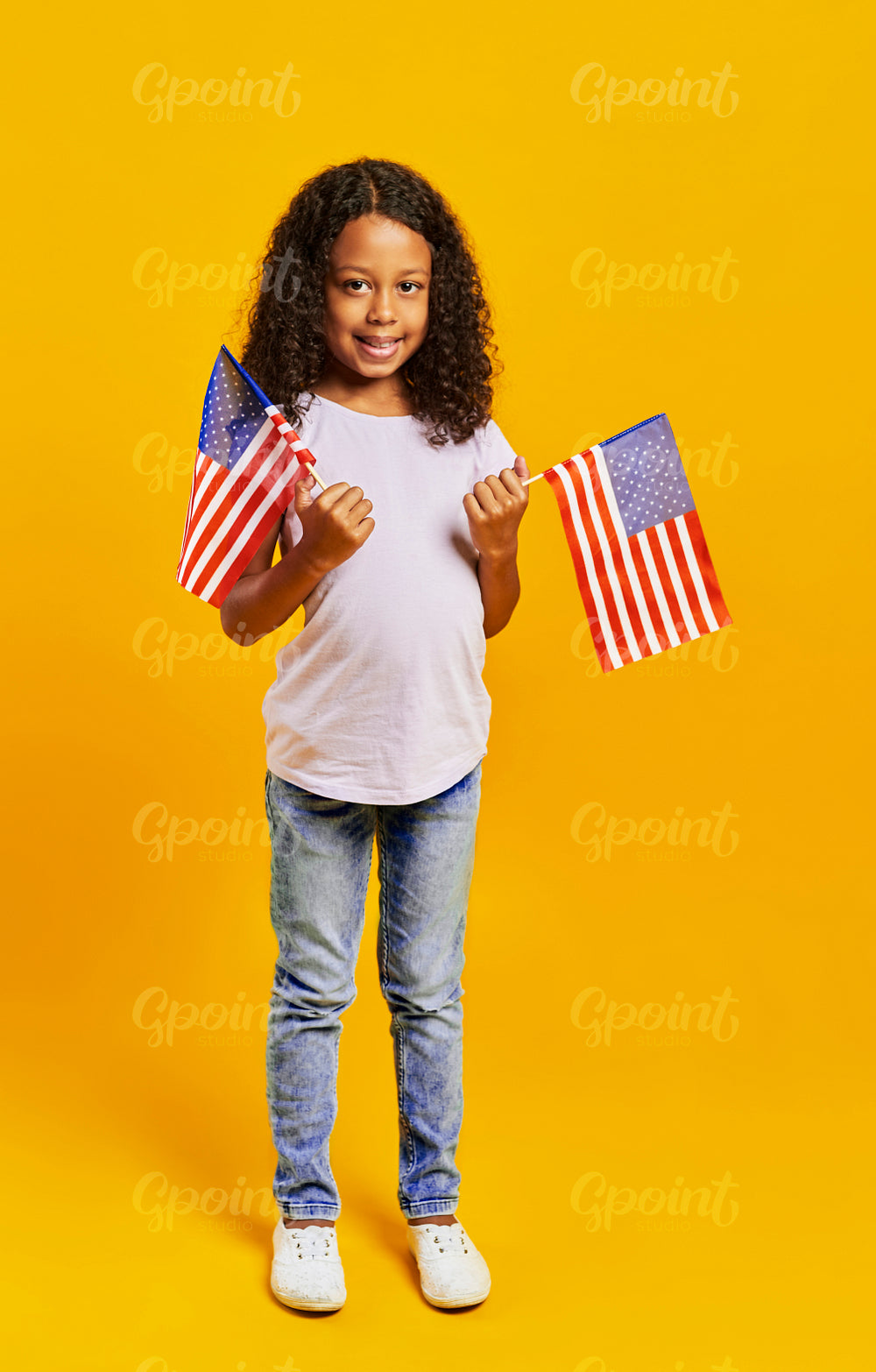 Portrait of African girl holding American flags