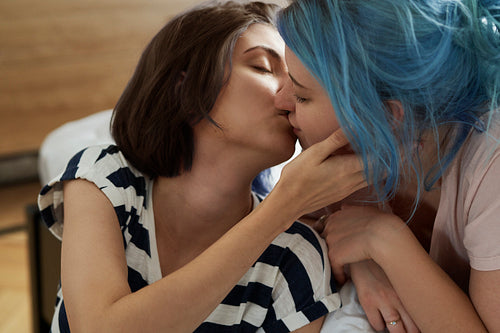 Romantic lesbian couple kissing intimately