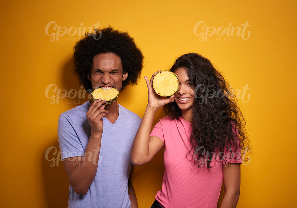 African couple with a slice of pineapple