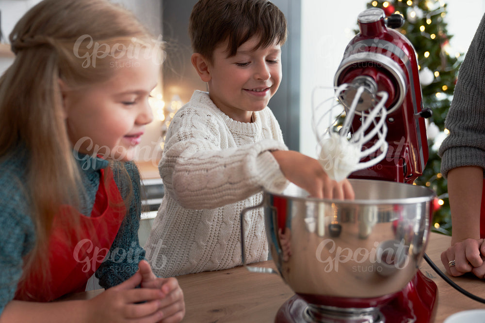 Children helping mother with Christmas baking