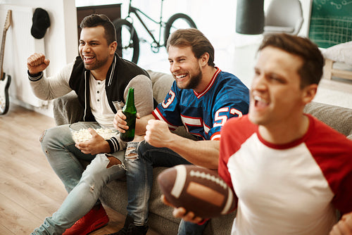Excited football fans watching american football