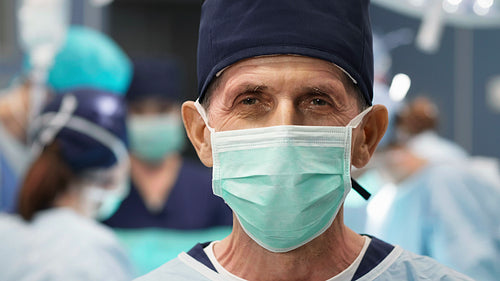 Portrait of mature surgeon at operating room