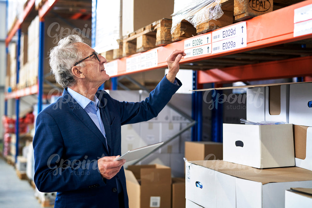 Caucasian leader in mature age working at warehouse 