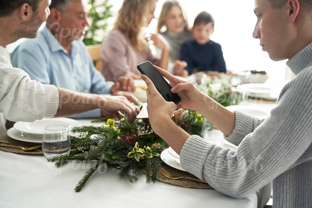 Caucasian man spending Christmas Eve with mobile phone