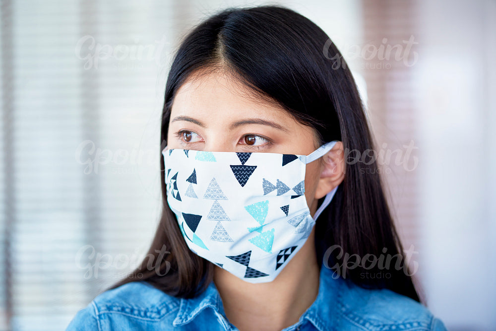 Asian woman in face mask in the office