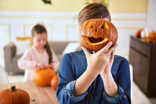 Boy with scary Halloween pumpkin