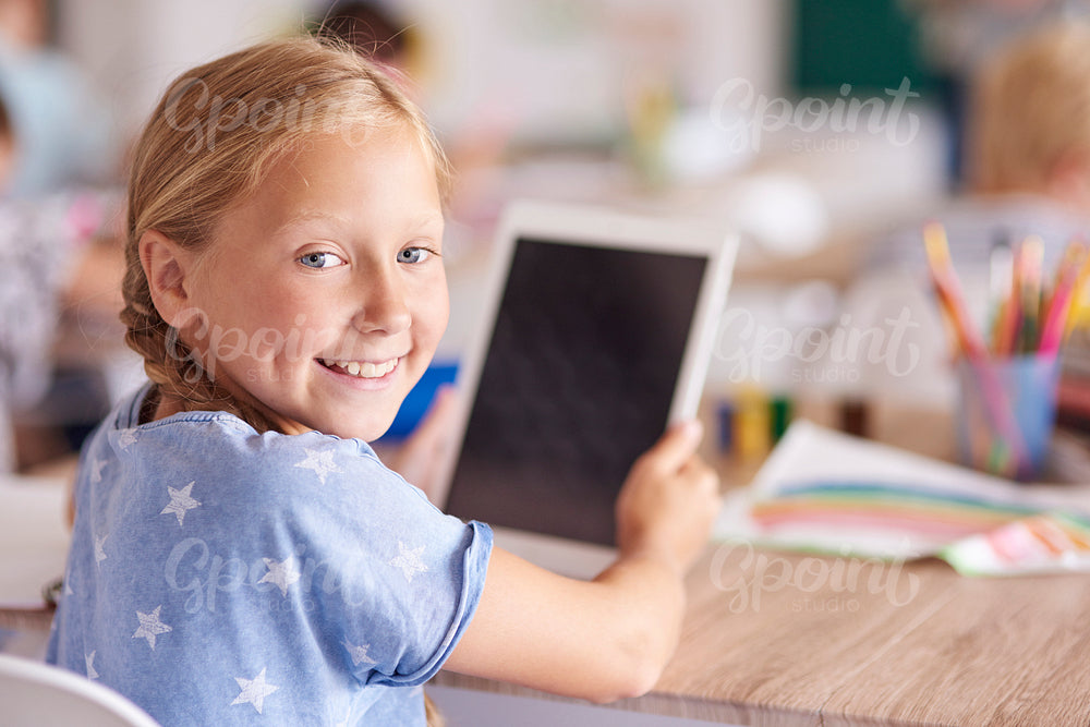 Girl using digital tablet at school