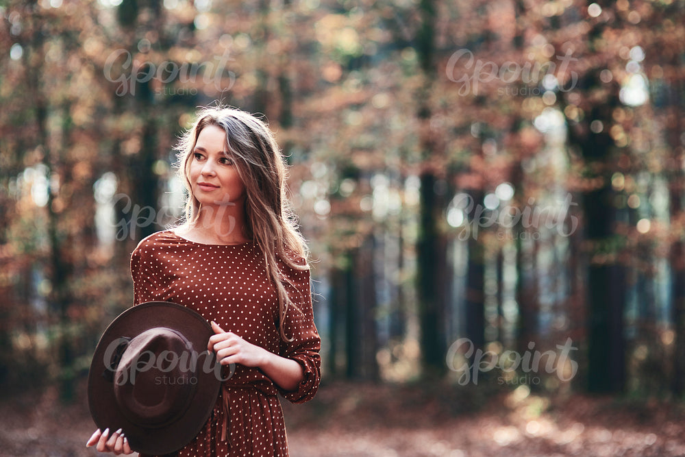 Woman walking in autumnal forest