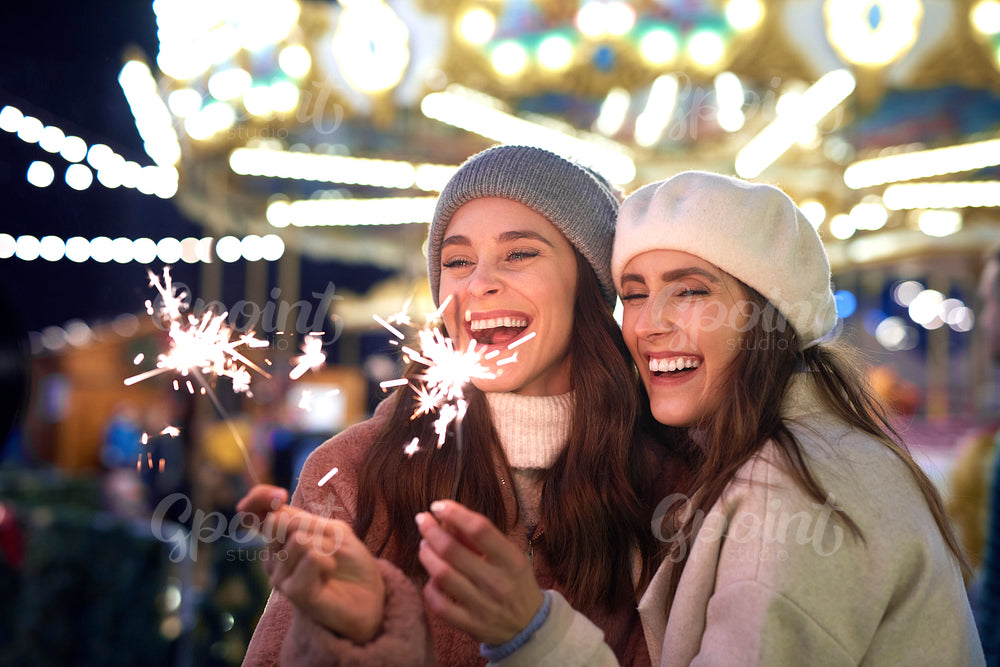 Best friends with sparklers on Christmas market
