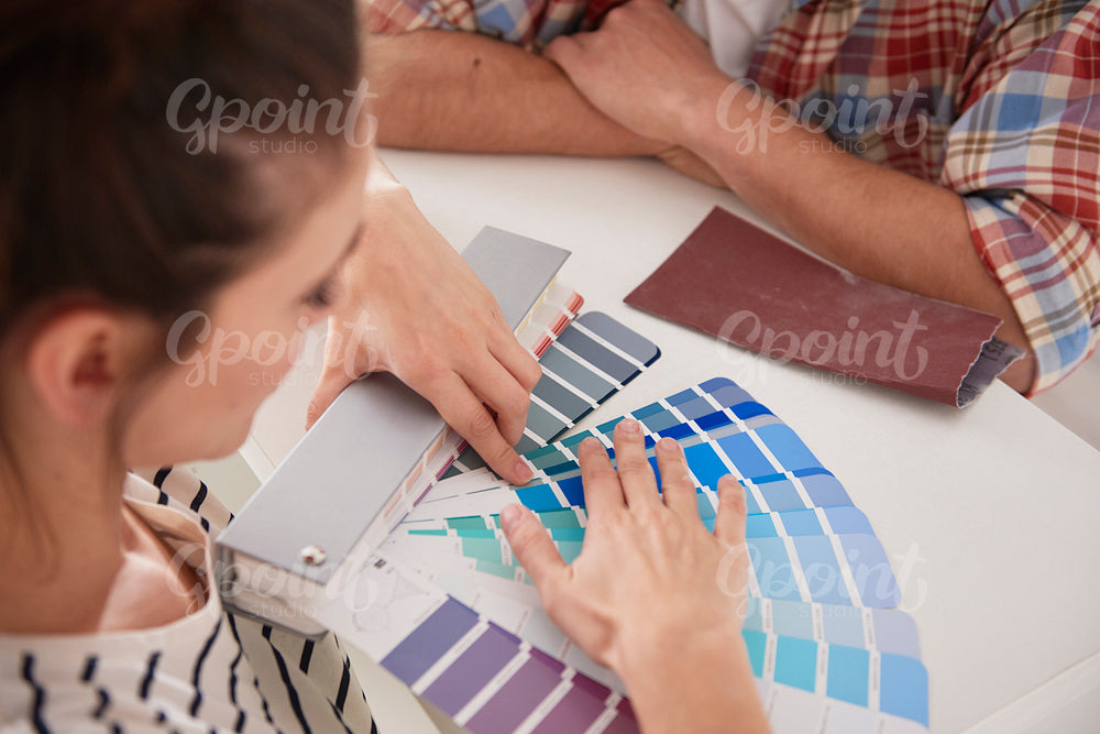 Young couple choosing new colors for the house