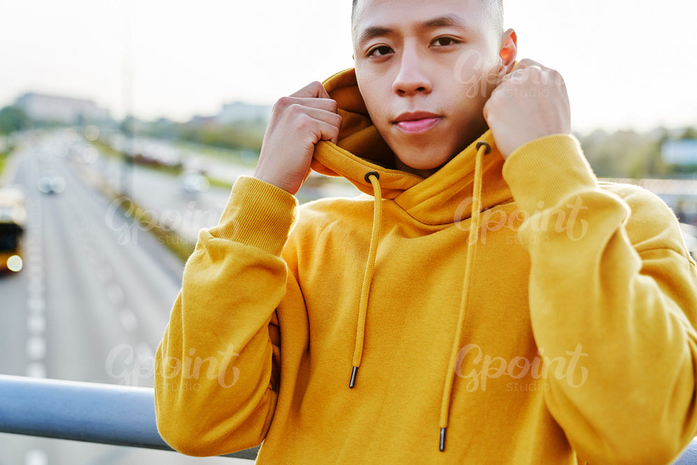Portrait of young man outdoors and traffic in the background