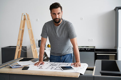 Portrait of  carpenter while installing kitchen furniture