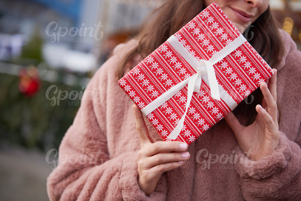 Close up of unrecognizable woman with Christmas gift