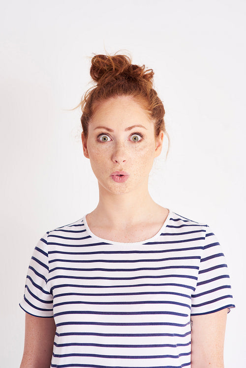 Portrait of young, surprised woman at studio shot