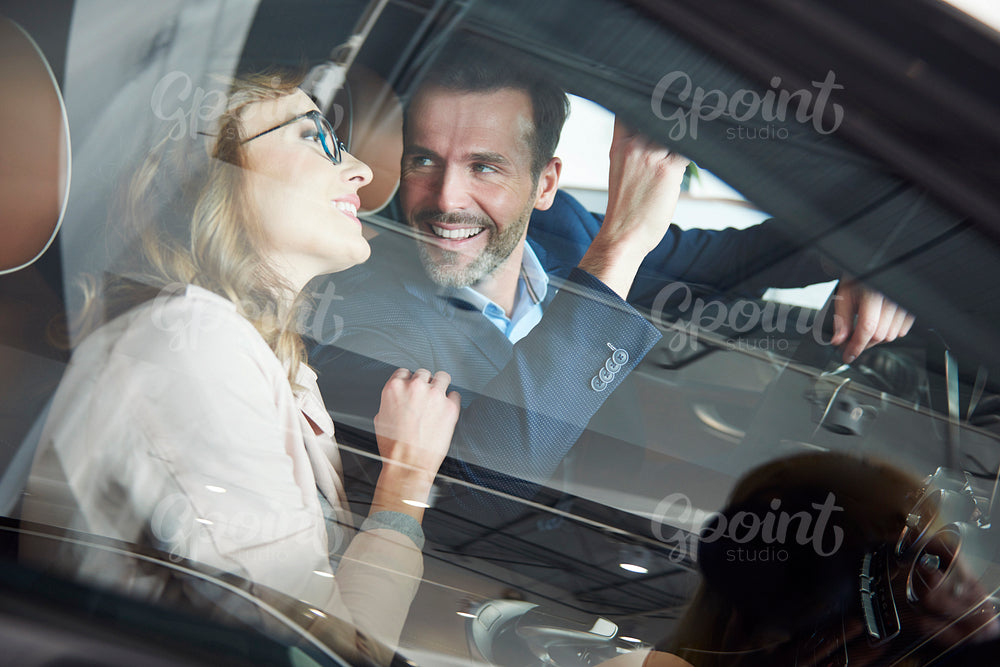 Shot through the car window of customers couple