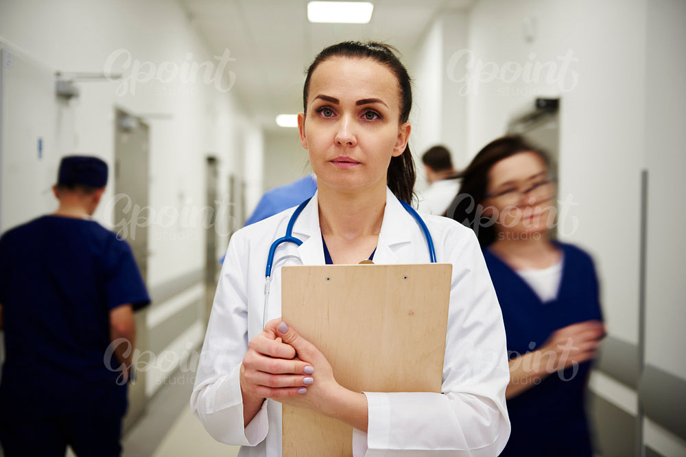 Portrait of female doctor with medical record