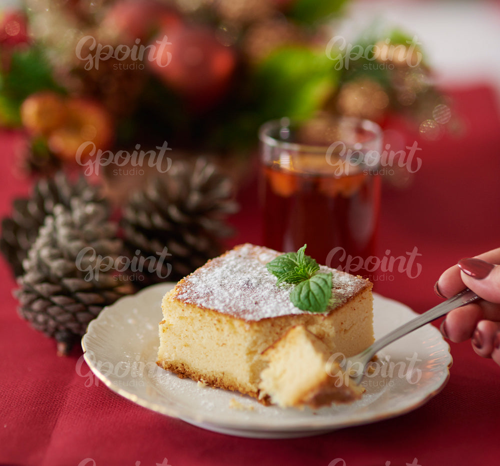 Cutting a piece of traditional cheesecake