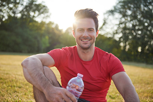 Smiling man resting after workout on the fresh air