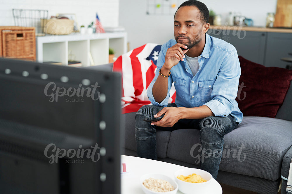 Man not very satisfied of what he sees on TV