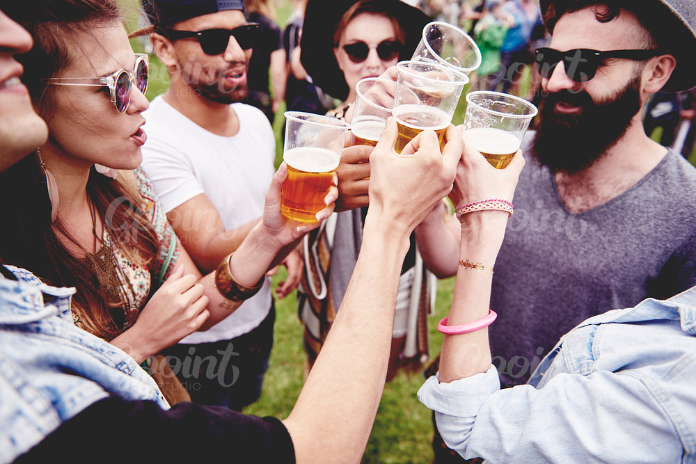 Group of friends drinking a beer at the festival