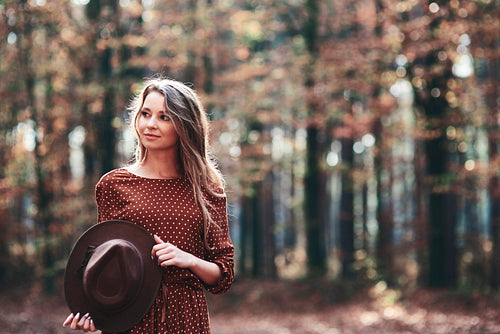 Woman walking in autumnal forest
