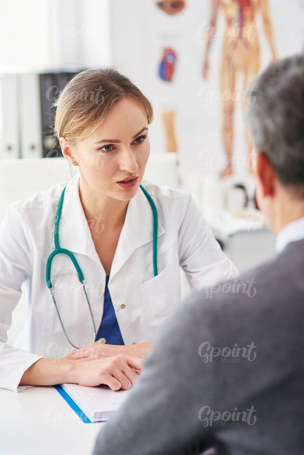 Female doctor talking to her patient in doctor’s office