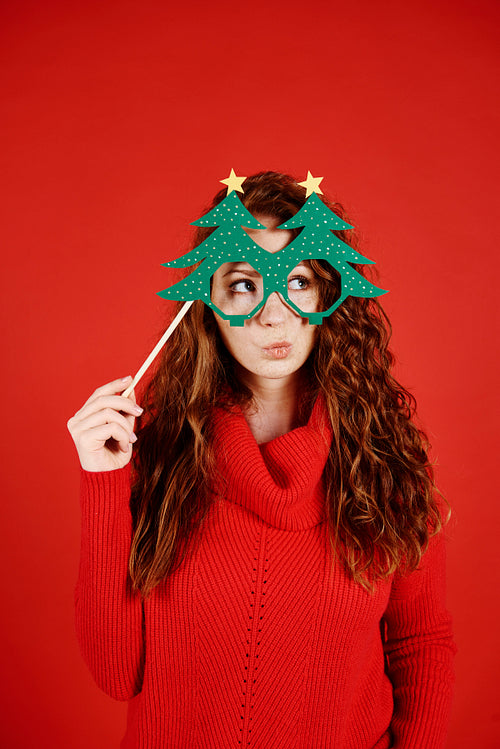 Girl with christmas mask looking at copy space