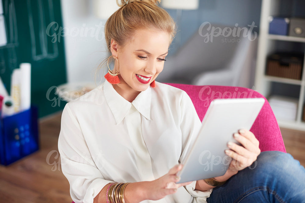 Woman with digital tablet at home office