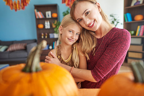 Loving mom and daughter with Halloween pumpkin