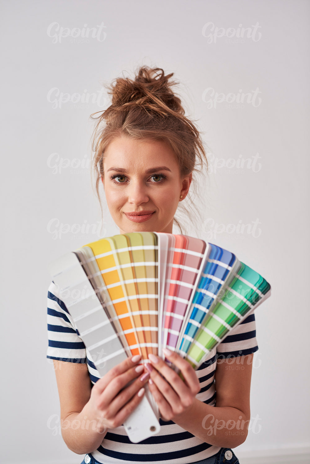 Portrait of smiling woman showing color swatch
